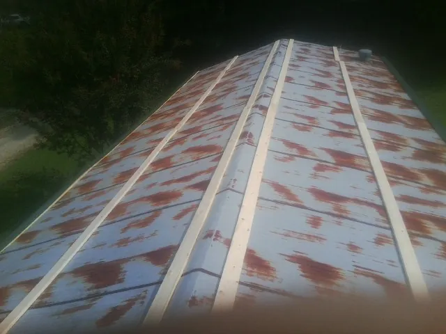 Rusted metal roof panels with new wood purlins before replacement — Storm Damage Roof Repair in Palo Alto by Roofing Brothers